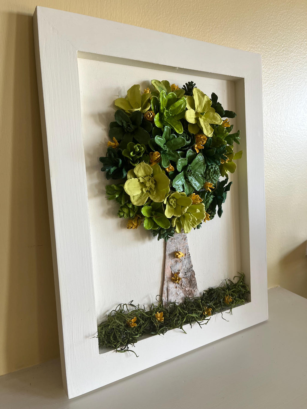 Wall Hanging Hand Painted Pine Cones Tree with in shades of green with yellow flowers - frame is cream colored and is real wood
