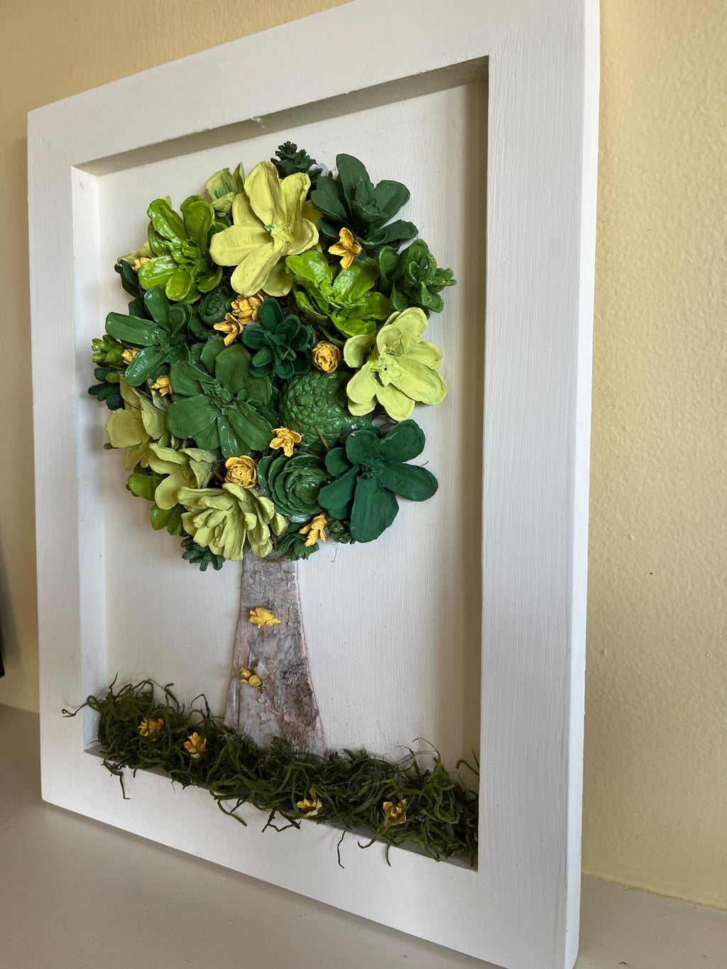 Wall Hanging Hand Painted Pine Cones Tree with in shades of green with yellow flowers - frame is cream colored and is real wood