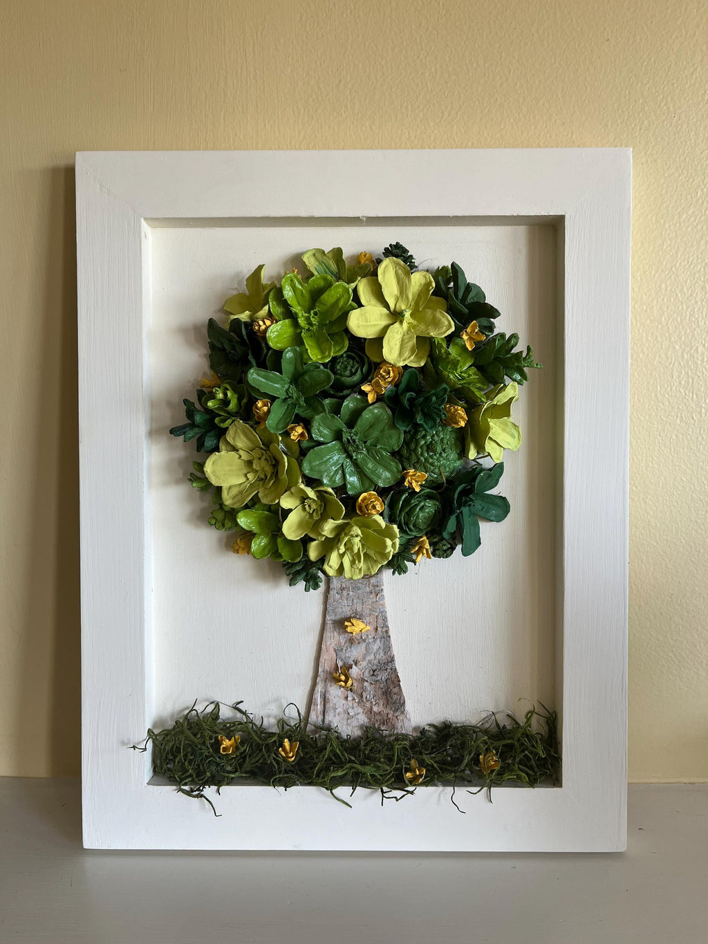 Wall Hanging Hand Painted Pine Cones Tree with in shades of green with yellow flowers - frame is cream colored and is real wood